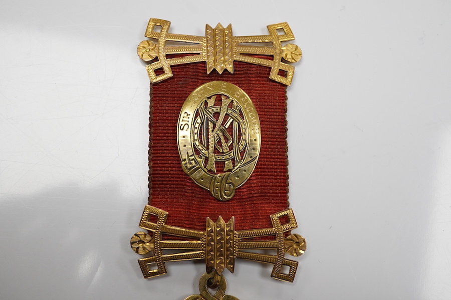 A 9ct gold Masonic 'Royal Order of Antedeluvian Buffaloes' medal, circa 1949, designed as a Maltese cross centring on a buffalo's face with garnet eyes, within a blue enamel garter border, inscribed 'Royal Order of Anted